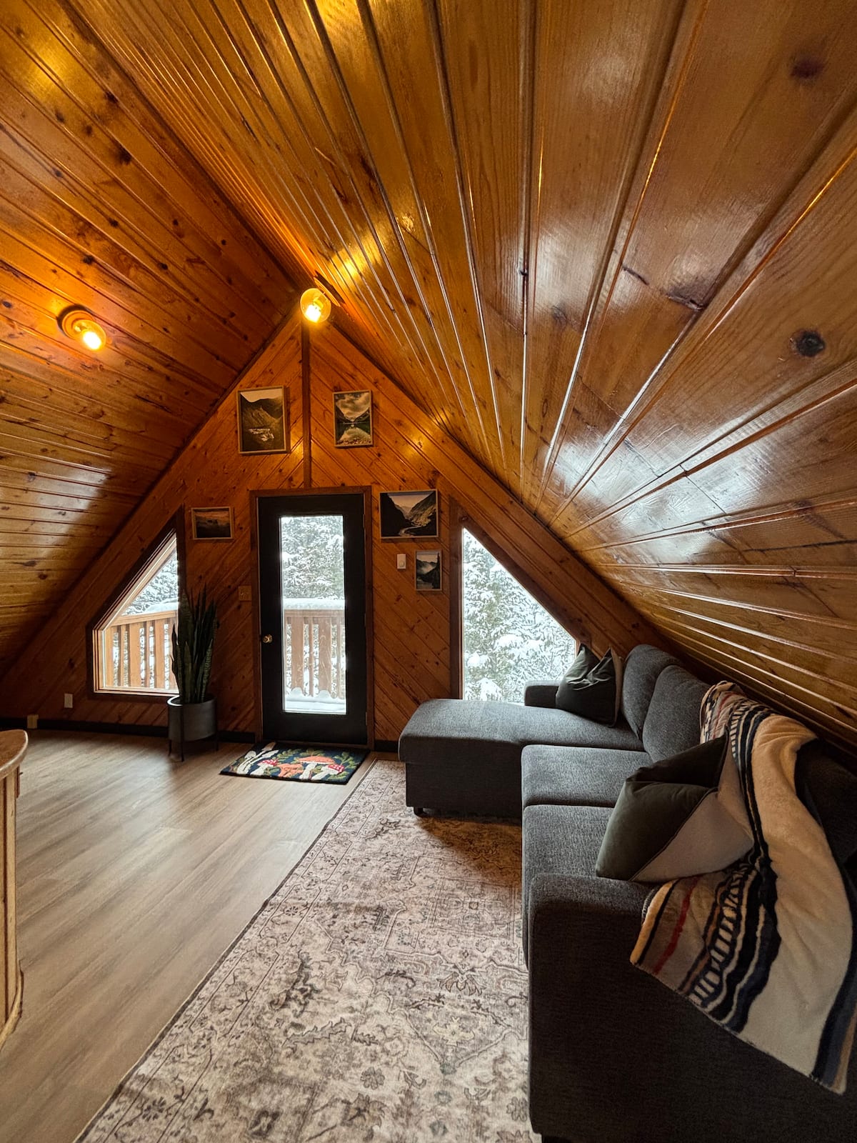 Wood-lined living room at Cozy Cab-Inn